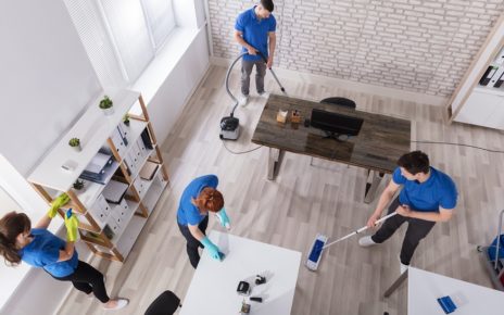 Group Of Janitors In Uniform Cleaning The Office With Cleaning Equipments