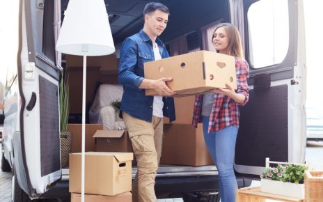 Young Couple Unloading Van