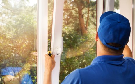 worker installing new plastic pvc window